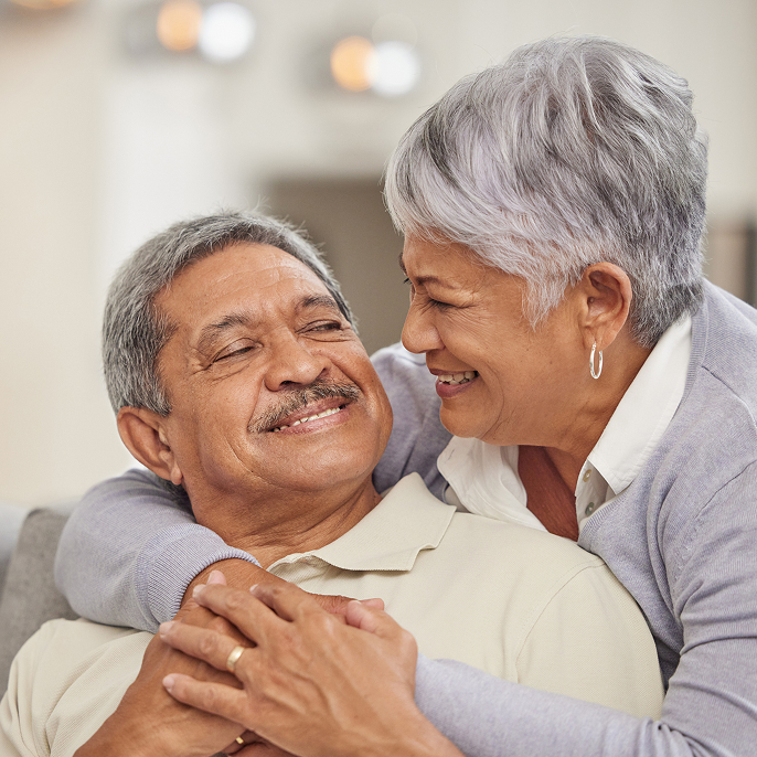 Older couple are embracing.
